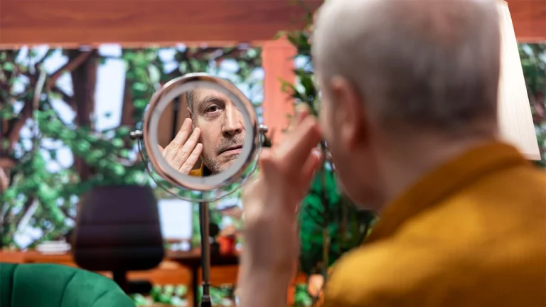 elderly-man-looking-in-the-mirror-at-his-wrinkles